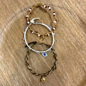 NWOT HANDMADE set of 3 leather, crystal, and wire bracelets with charms.